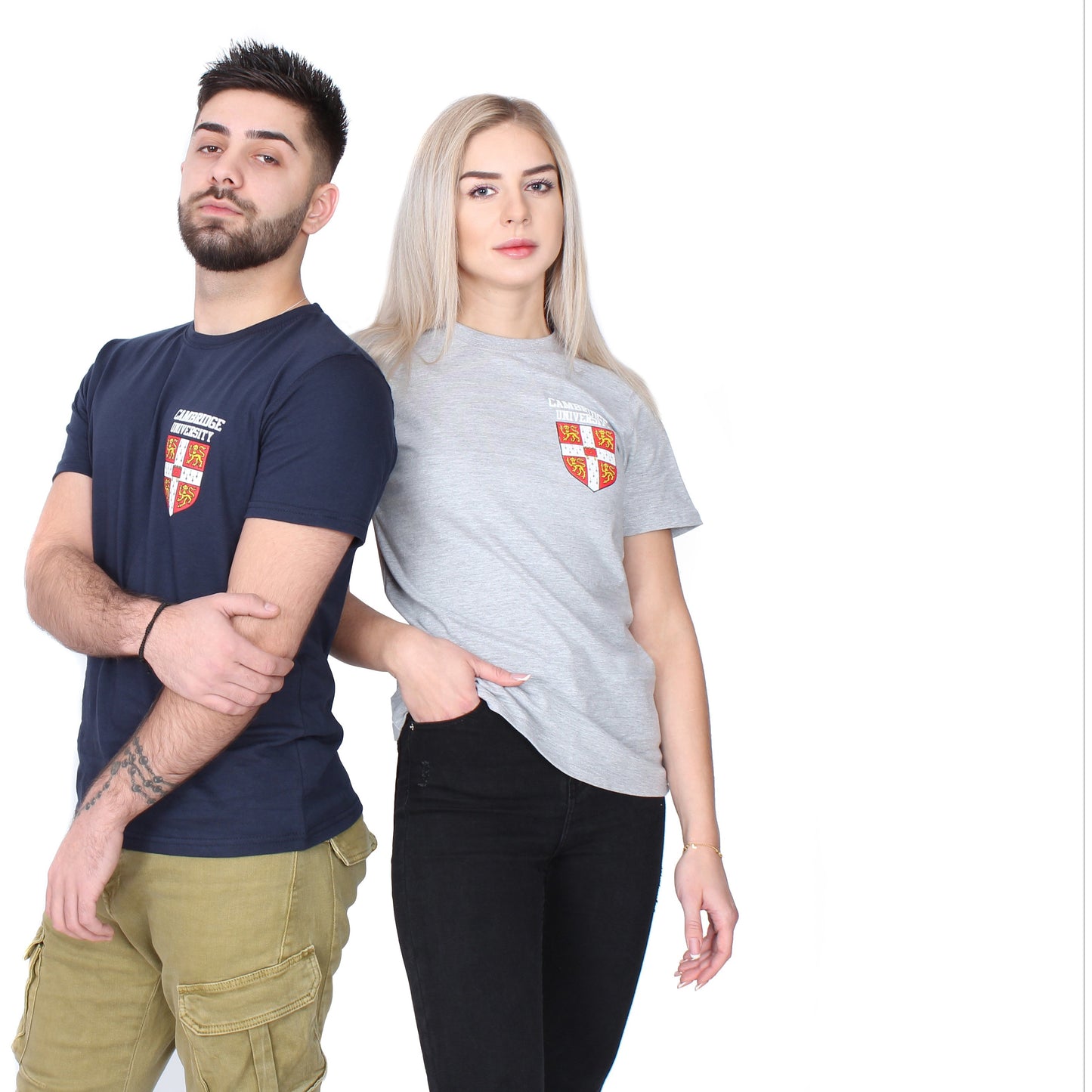 Two models, one wearing navy blue T-shirt with the University of Cambridge shield, and the other light grey with same design.