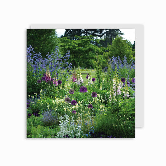 A greeting card depicting a colorful garden with a variety of flowers and greenery.