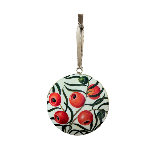 Decorative circular Christmas ornament with red yew berries and green leaves on a white background