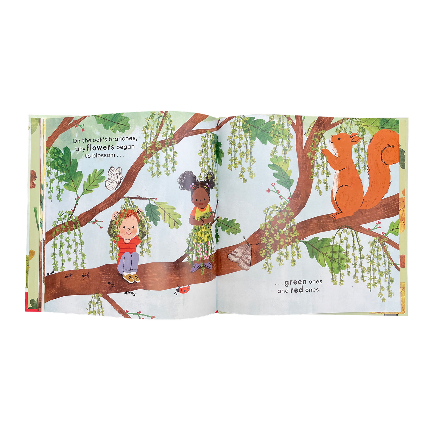 Illustrated book open to a page with children and animals on tree branches.