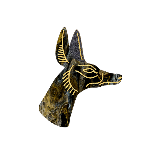 Decorative brooch in Egyptian jackal design. Swirling gold and black acrylic with hand-inked gold detailing.