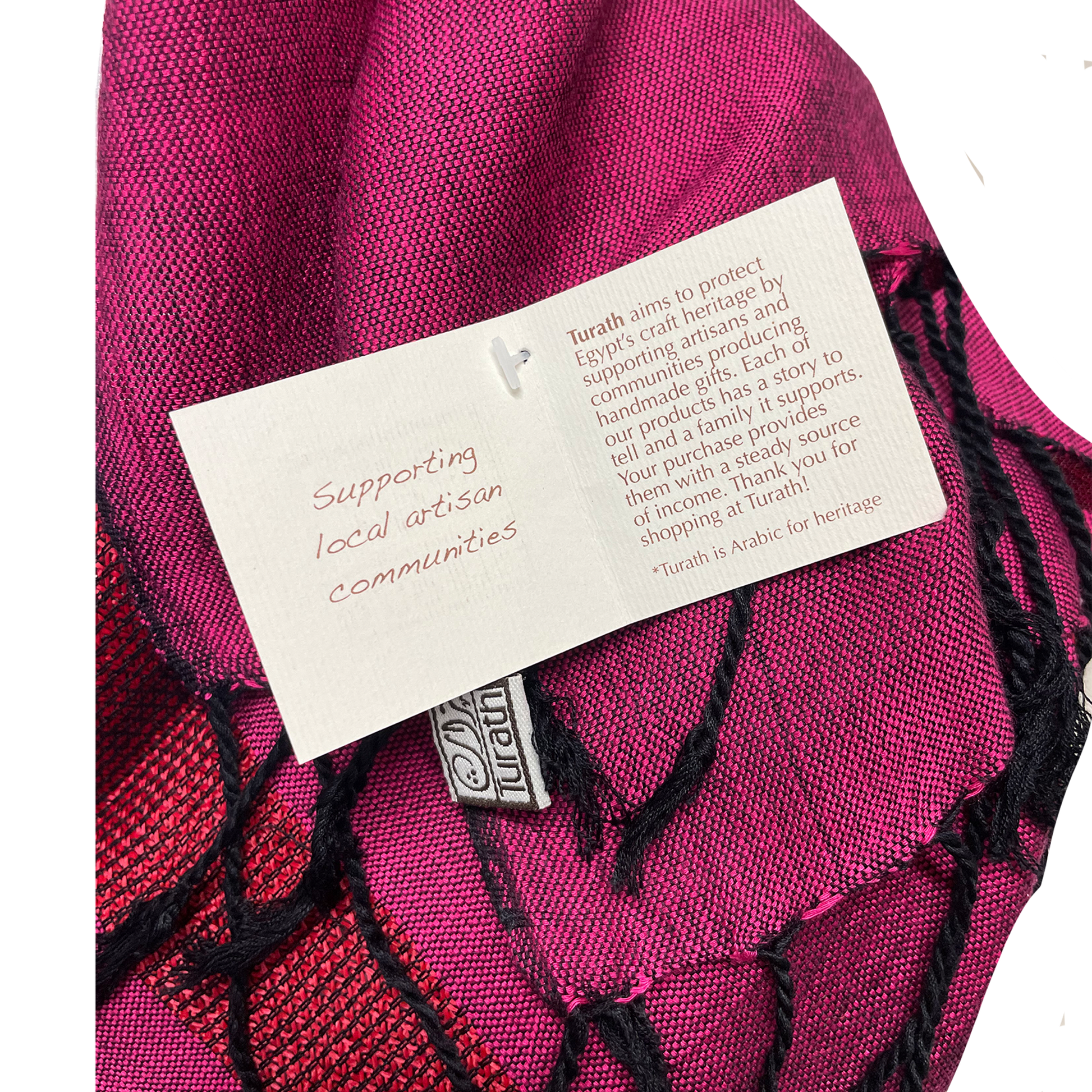 Pink fabric with a label and Turath logo on a white background