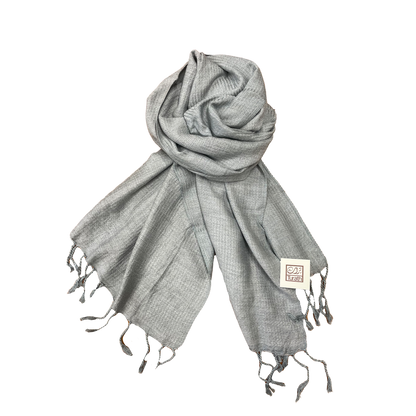 Gray scarf with tassels on a white background
