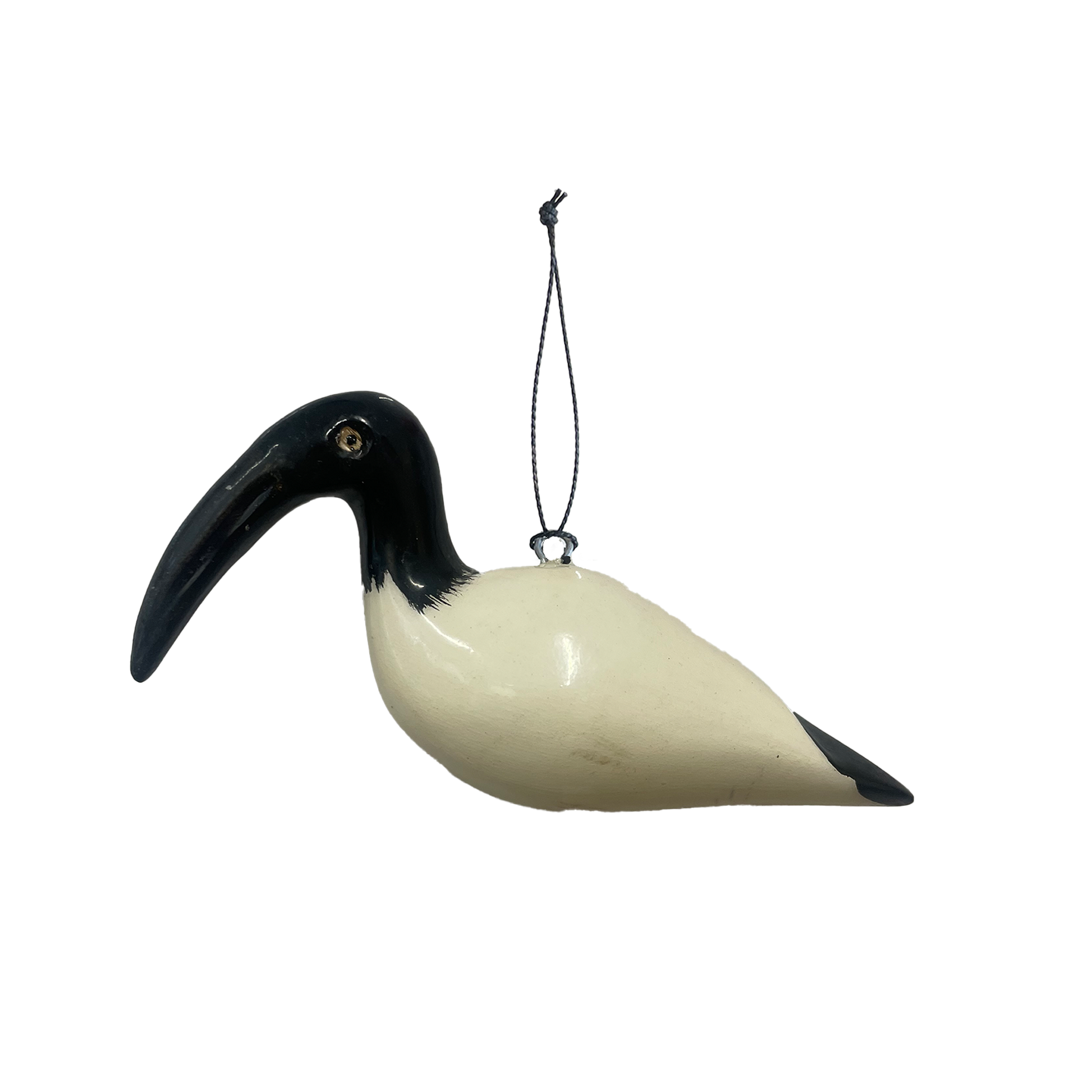 Decorative painted wooden bird ornament with a black beak and white body hanging on a white background