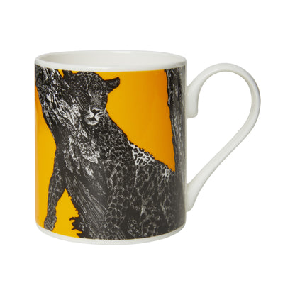 Bone china mug with design of sleeping leopard in black and white, with yellow background. White inner and handle. From the collection of the Museum of Zoology.