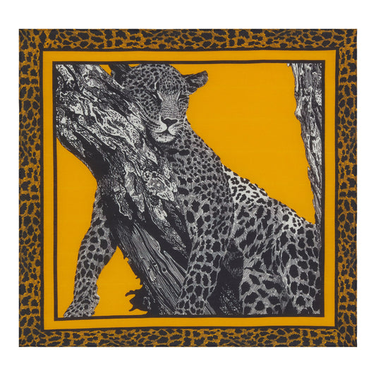 Square bandana scarf. Black and white design of a leopard sleeping on a tree branch, against a mustard yellow background. Bordered with a mustard yellow and black leopard print design.