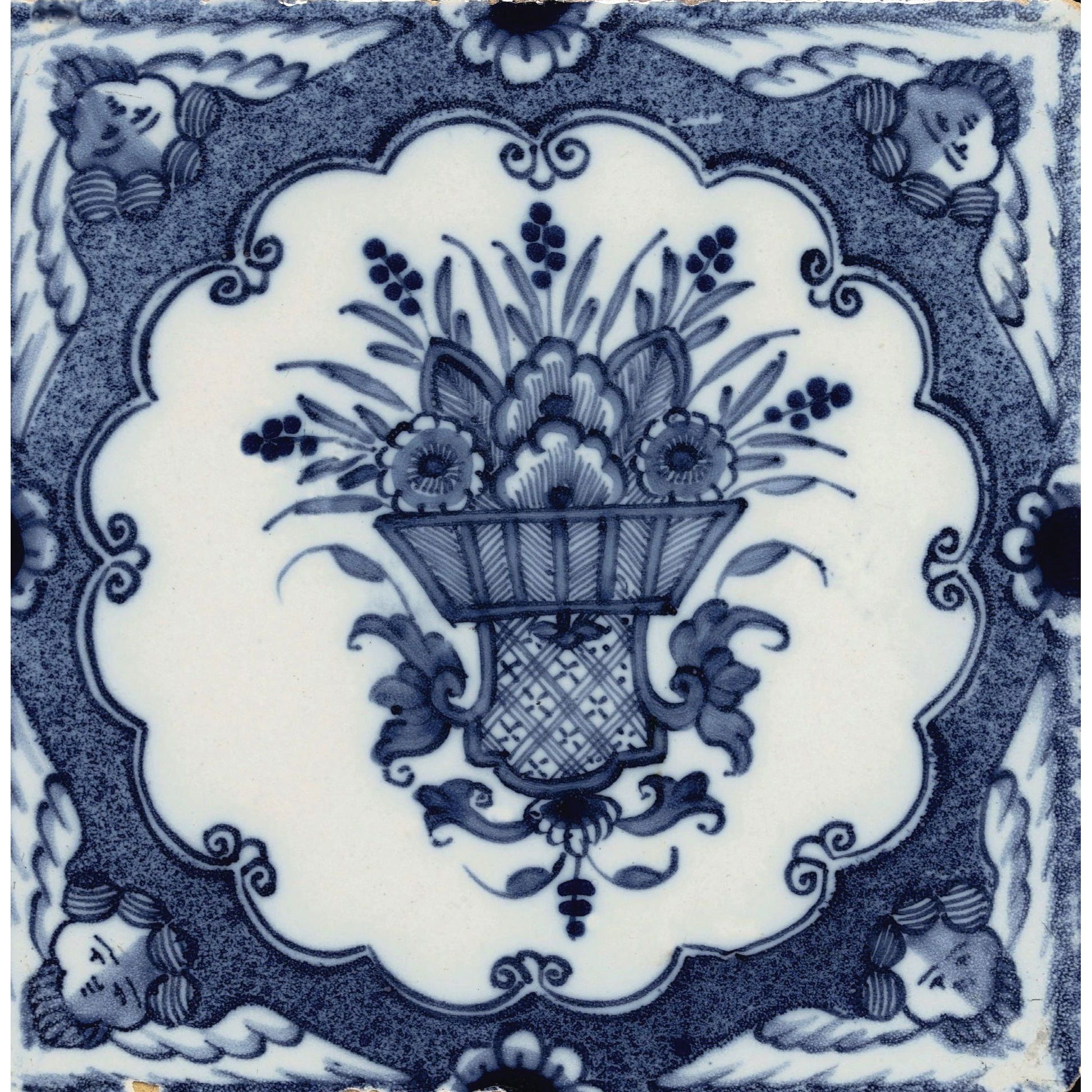 Square greeting card - blue and white tile with central design of flowers in a container, with a scalloped edge border and cherub's heads decorating each corner. From the collection of The Fitzwilliam Museum, brought to you by CuratingCambridge.com