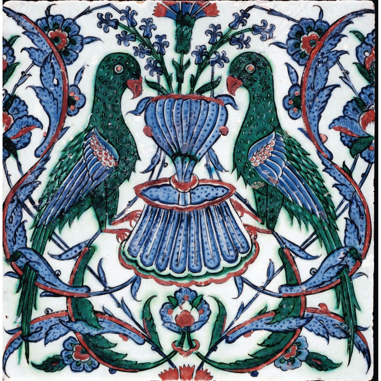 Square greeting card - tile with green parrots flanking a blue fountain. Floral motifs around in blue, green, and red highlights. From the collection of The Fitzwilliam Museum, brought to you by CuratingCambridge.com